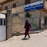 A woman walking in front of the Community Development Centre in Akkar, Lebanon
