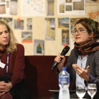 Two panellists talking into microphones at the event