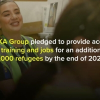 A still from the video showing a woman in protective clothing smiling in a warehouse, and the words "INGKA Group pledged to provide access to training and jobs for an additional 3,000 refugees by the end of 2027"