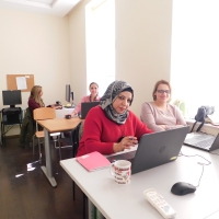 Women with laptops in a classroom.