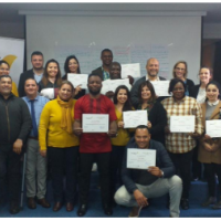 People standing holding a certificate.