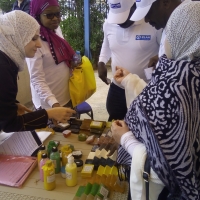 Woman around a table selling soap.