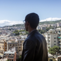 A boy looks out over a city.