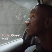 A young man looks out of a car window