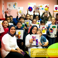 Woman and kids holding images facing the camera.