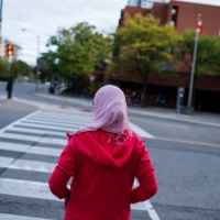 Woman waiting to cross a road