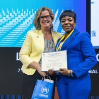 Yvonne Ndaga, Endam Home of Hope, of Nigeria, winner of a 2022 NGO Innovation Award, receiving her award from UNHCR Deputy High Commissioner, Kelly Clements