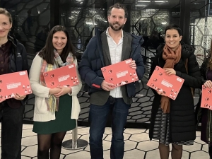 Group photo of people holding report which was launched at the event