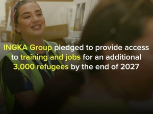 A still from the video showing a woman in protective clothing smiling in a warehouse, and the words "INGKA Group pledged to provide access to training and jobs for an additional 3,000 refugees by the end of 2027"