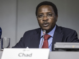 A man in a panel, speaking, with the nameplate of Chad in front of him