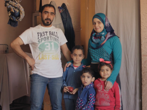 Family smiling and looking at the camera.