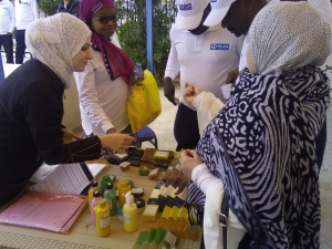 Woman around a table selling soap.