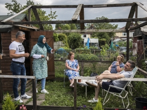 A group of people sitting in a garden smiling