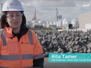 Still frame. A woman on a building site talks to camera