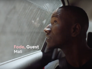 A young man looks out of a car window