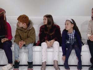 Children seated in a sofa.