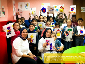 Woman and kids holding images facing the camera.