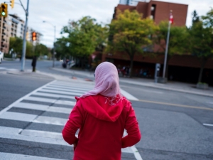 Woman waiting to cross a road