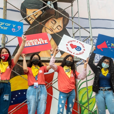 People wearing masks and holding up signs
