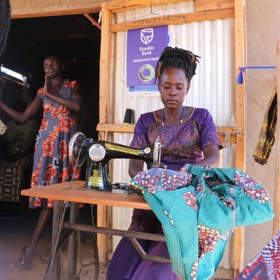 A woman is sewing a garment