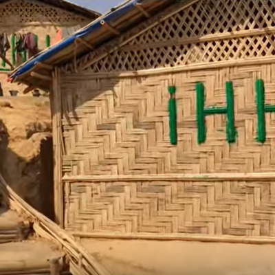 House made out of bamboo in a camp setting.