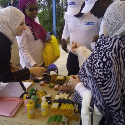 Woman around a table selling soap.