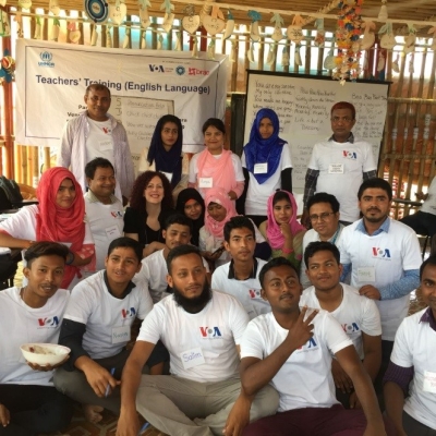 Group of people at a classroom setting in a camp.