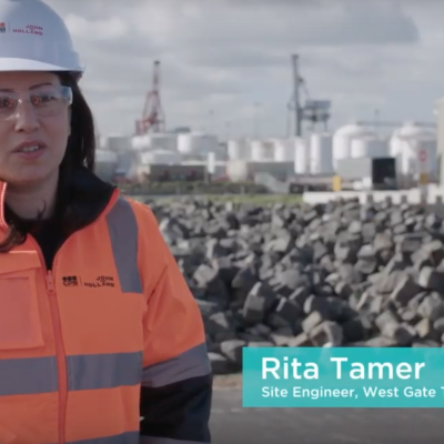 Still frame. A woman on a building site talks to camera