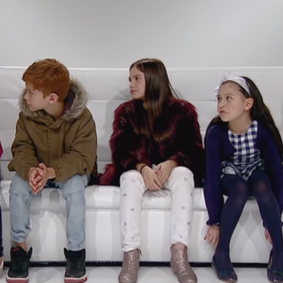 Children seated in a sofa.