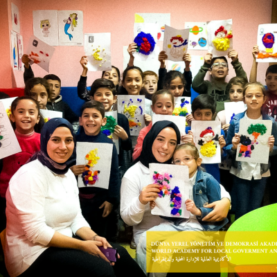 Woman and kids holding images facing the camera.