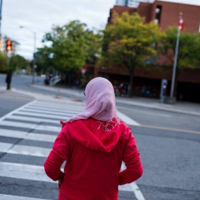 Woman waiting to cross a road