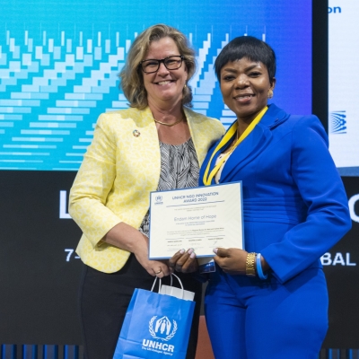 Yvonne Ndaga, Endam Home of Hope, of Nigeria, winner of a 2022 NGO Innovation Award, receiving her award from UNHCR Deputy High Commissioner, Kelly Clements
