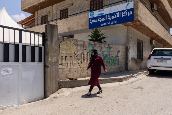 A woman walking in front of the Community Development Centre in Akkar, Lebanon