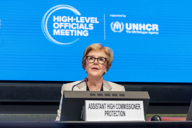Woman sitting at podium