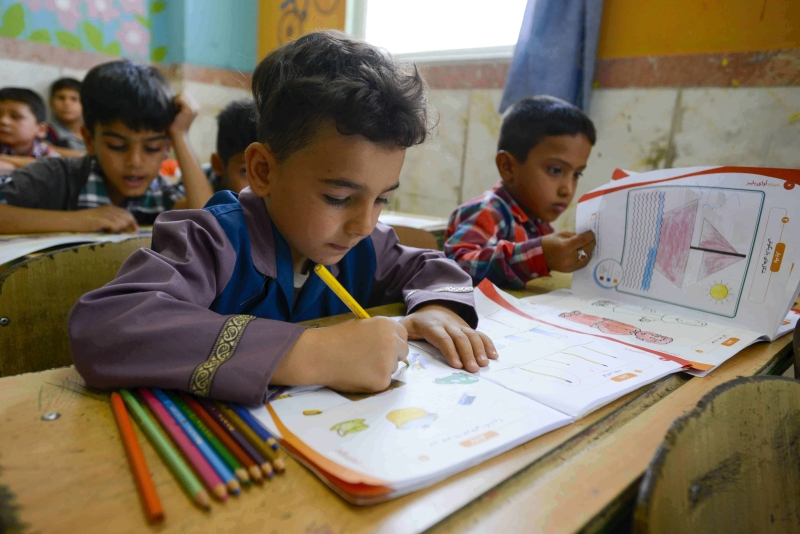 Two schoolboys studying in a classroom