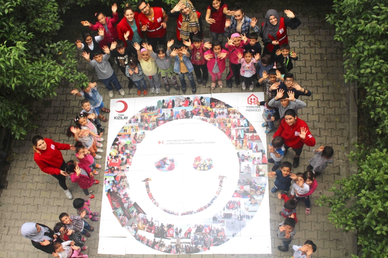 A group of people looking up at the camera and smiling
