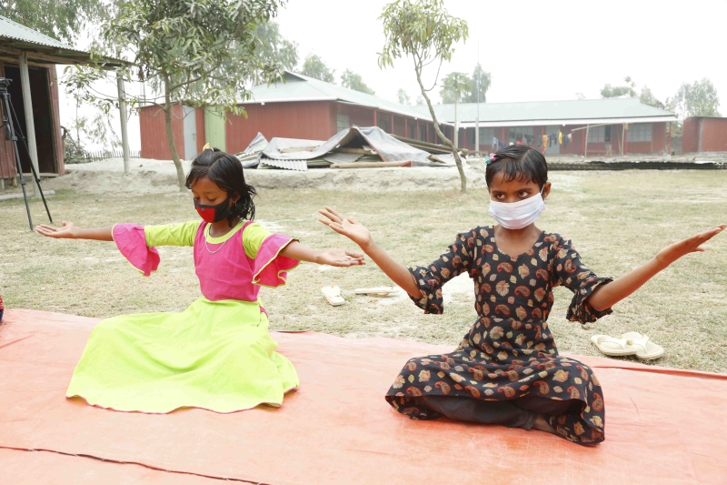 Two children sitting cross-legged