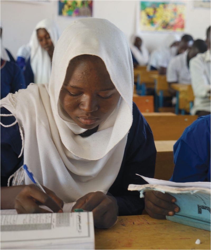 A woman sitting in a classroom studying
