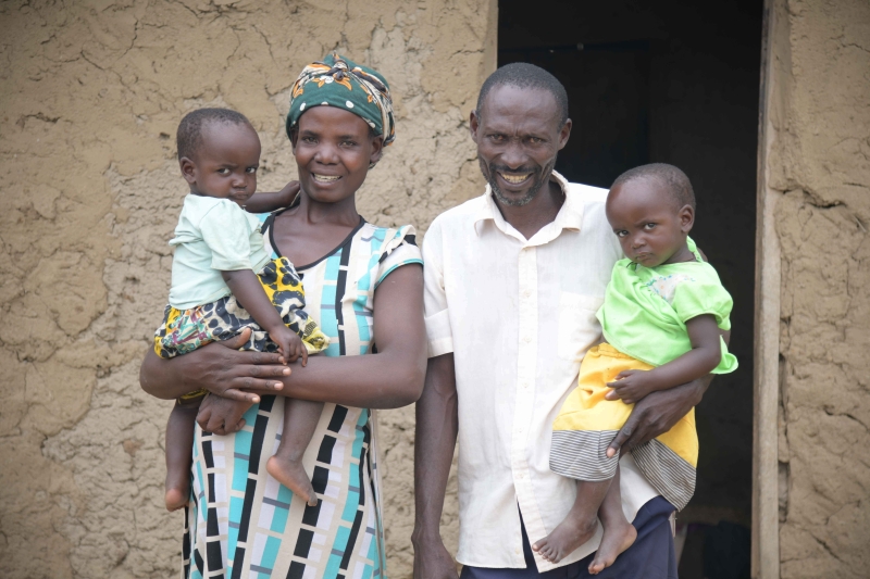 A woman, man and two children smiles to the camera