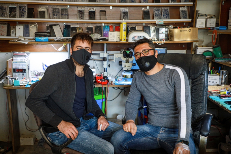 Two men wearing face masks