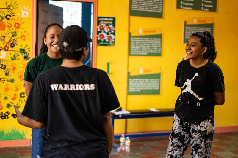 Three girls talking and smiling