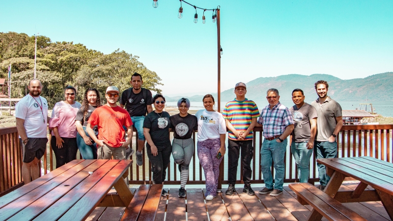 A group of people pose facing the camera and smile
