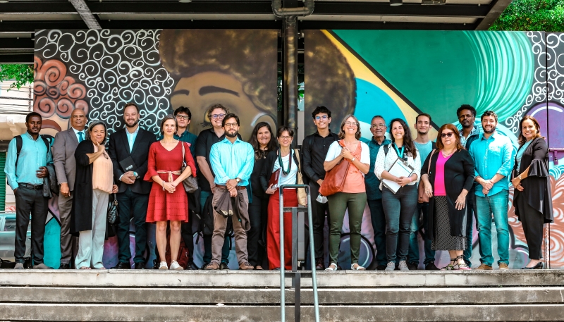 A group of people face the camera and smile