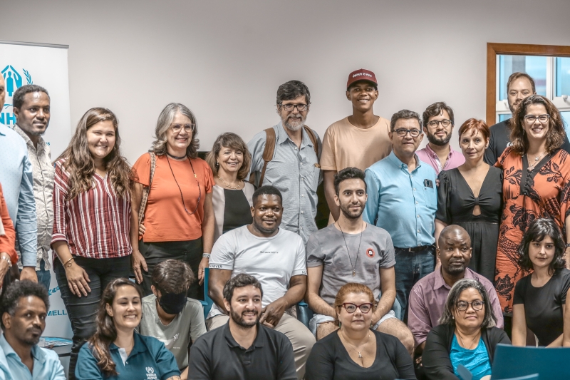 A group of people face the camera and smile