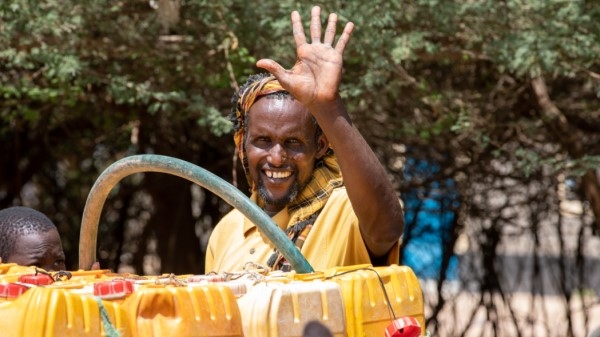 a water vendor fetches water for sale at the water ATM in Dagahaley camp, Dadaab.