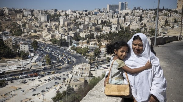 A woman and girl overlooking at city
