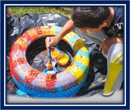 A child painting a tire