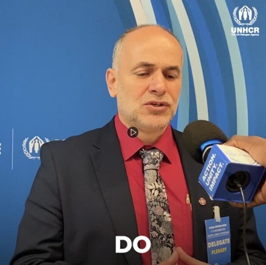 Mustafa Debashi with a microphone in front of him, at the GRF 2023