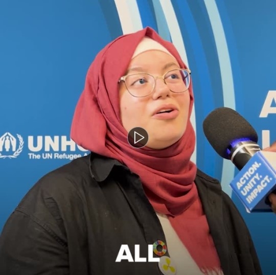 Areej Alsayed with a microphone in front of her, at the GRF 2023