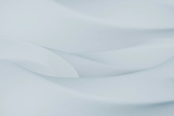 A white and light grey image with a wavy pattern